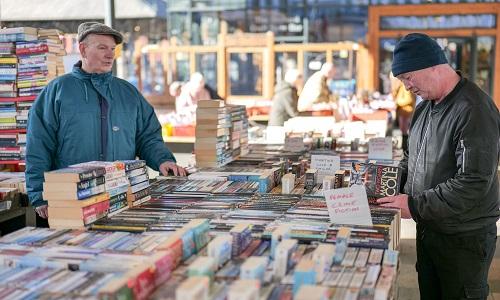 Customer at The Book Stops Here Stall