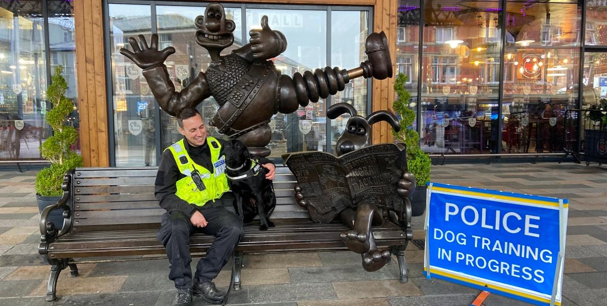 Police man and training dog on Wallace and Gromit bench