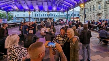 People enjoying live music outside The Orchard Bar