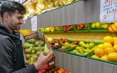 Trader holding box of pears