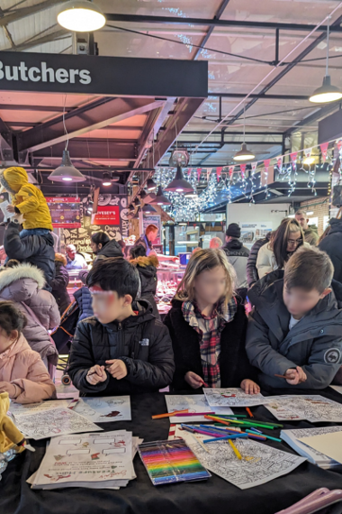 Group of children colouring at craft table