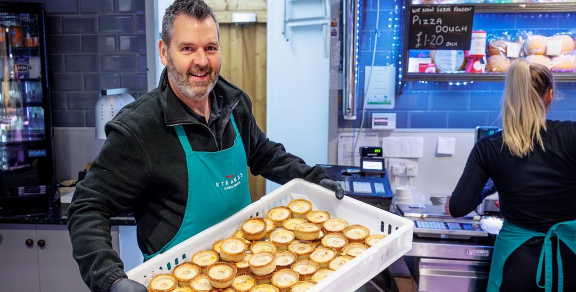 Trader with tray of pork pies