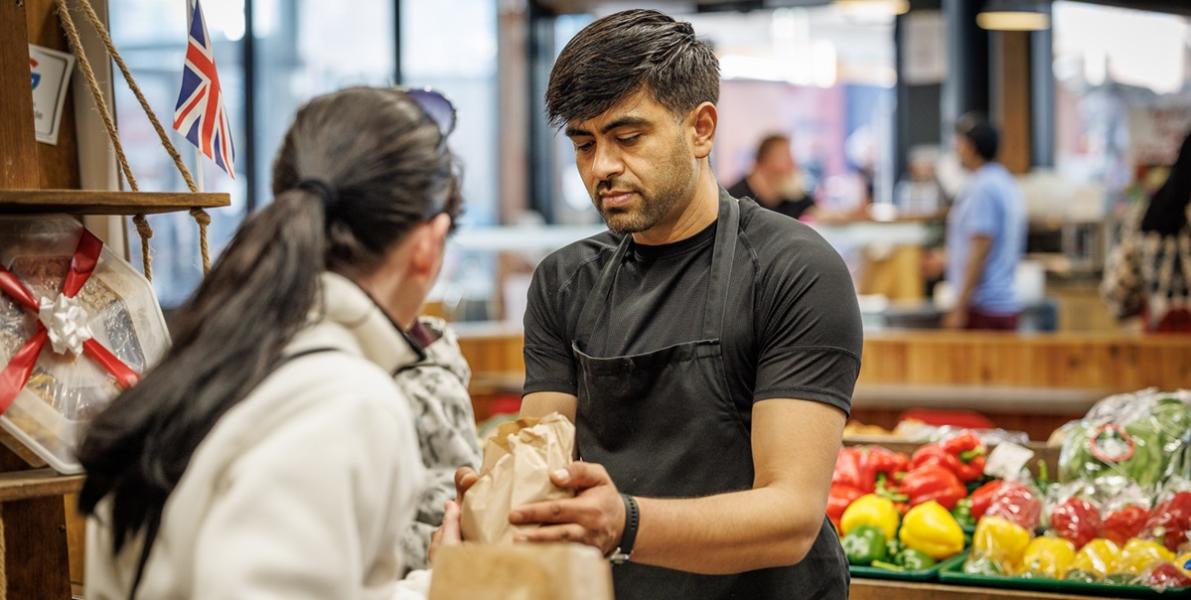 SuperVeg trader serving customer