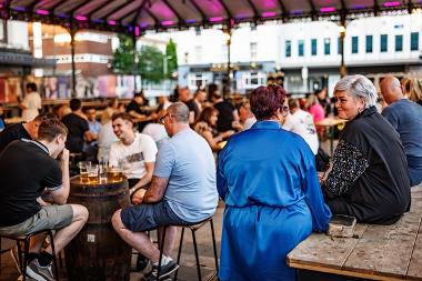 People drinking and socialising at The Orchard